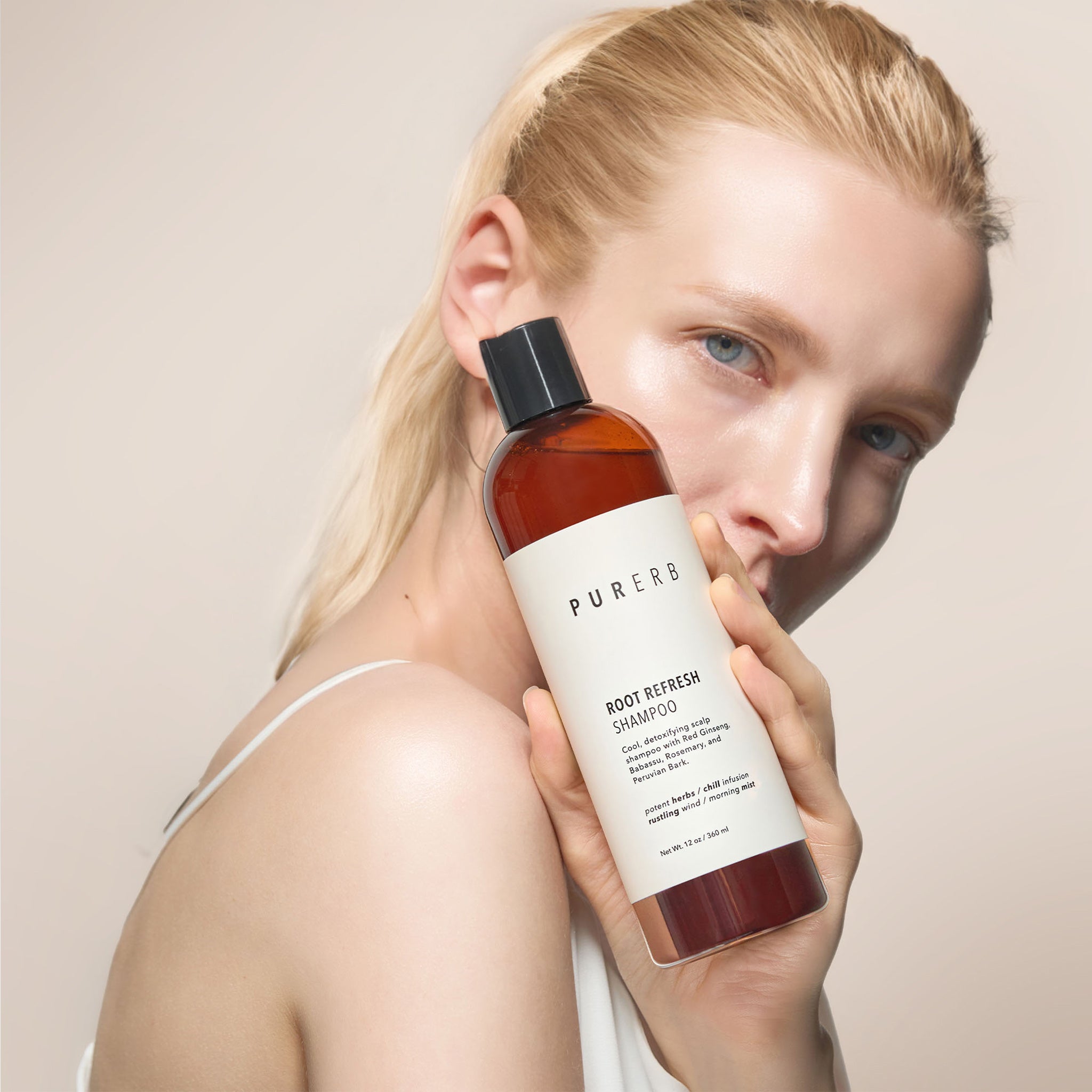 Root Refresh Shampoo bottle – A revitalizing solution for frizz-free, silky hair. This shampoo detoxifies and nourishes oily roots and tired strands with hydrating oils and botanical extracts, offering a refreshing and hair-fortifying experience with an amazing scent.