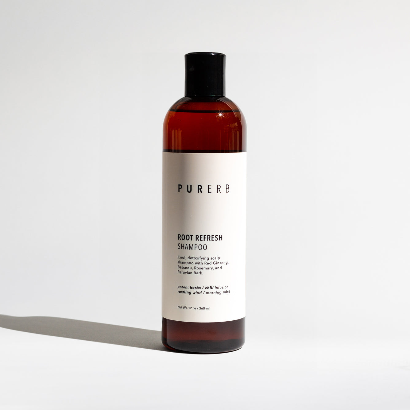 Root Refresh Shampoo bottle – A revitalizing solution for frizz-free, silky hair. This shampoo detoxifies and nourishes oily roots and tired strands with hydrating oils and botanical extracts, offering a refreshing and hair-fortifying experience with an amazing scent.